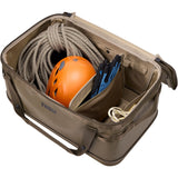 Thule Chasm Gear Hauler waterproof semi-rigid storage bag for travel and camping accessories, shown in outdoor setting.