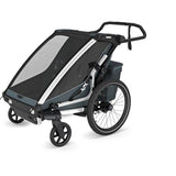 Thule Chariot Cross 2 double child carrier with cycling and strolling kits, shown with secure harnesses and adjustable features.