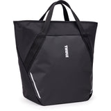 Thule Chasm Tote InLock 25L water-resistant bag with bike rack compatibility, featuring sturdy handles and secure locking system.