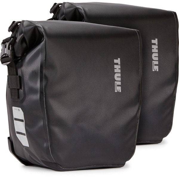 Thule Shield waterproof panniers with reflective panels and adjustable mounts for bike storage and security.