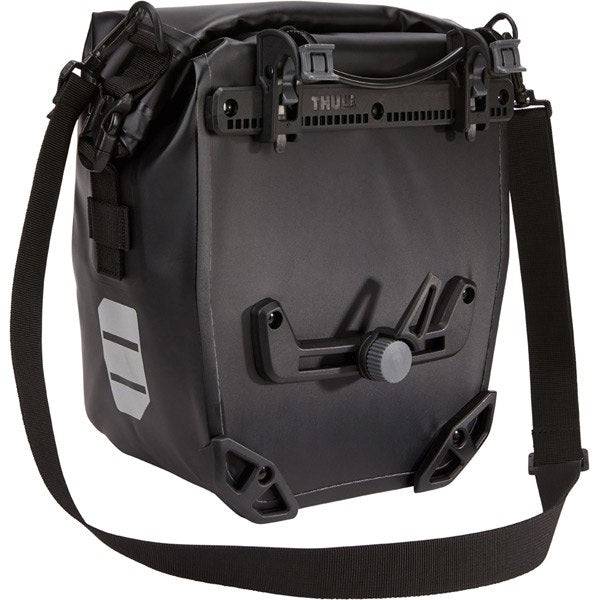 Thule Shield waterproof panniers with reflective panels and adjustable mounts, designed for bike storage and commuting.