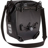 Thule Shield waterproof panniers with reflective panels and adjustable mounts, designed for bike storage and commuting.