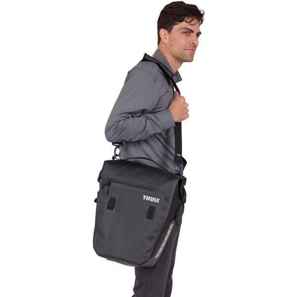 Black Thule Shield Commuter Pannier with 22L capacity, waterproof design, featuring a padded laptop sleeve for cycling accessories.