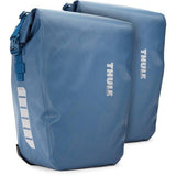 Thule Shield waterproof panniers with reflective panels and adjustable mounts, designed for secure bike cargo storage.
