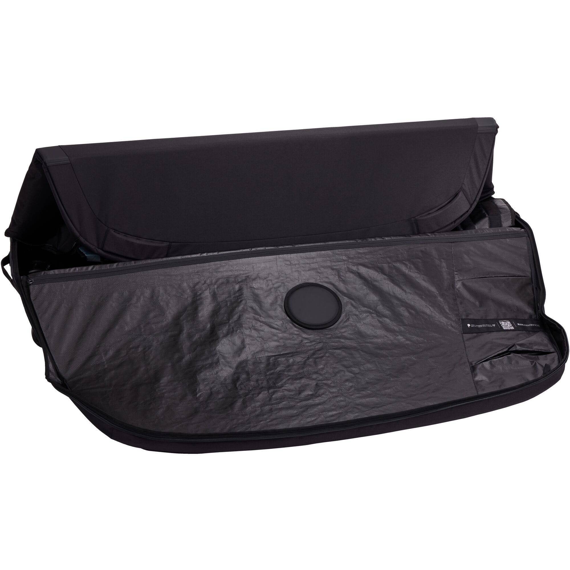 Thule RoundTrip MTB bike case with integrated work stand, designed for mountain and road bikes, showing the sturdy case and stand setup.
