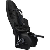 Black Thule Yepp 2 Maxi MIK HD child bike seat with click-in mounting system, showing secure attachment and ergonomic design.