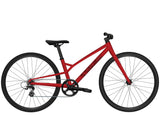 Trek Wahoo 26-inch mountain bike with kid-friendly trigger shifters, designed for beginner riders, outdoors on a dirt trail.