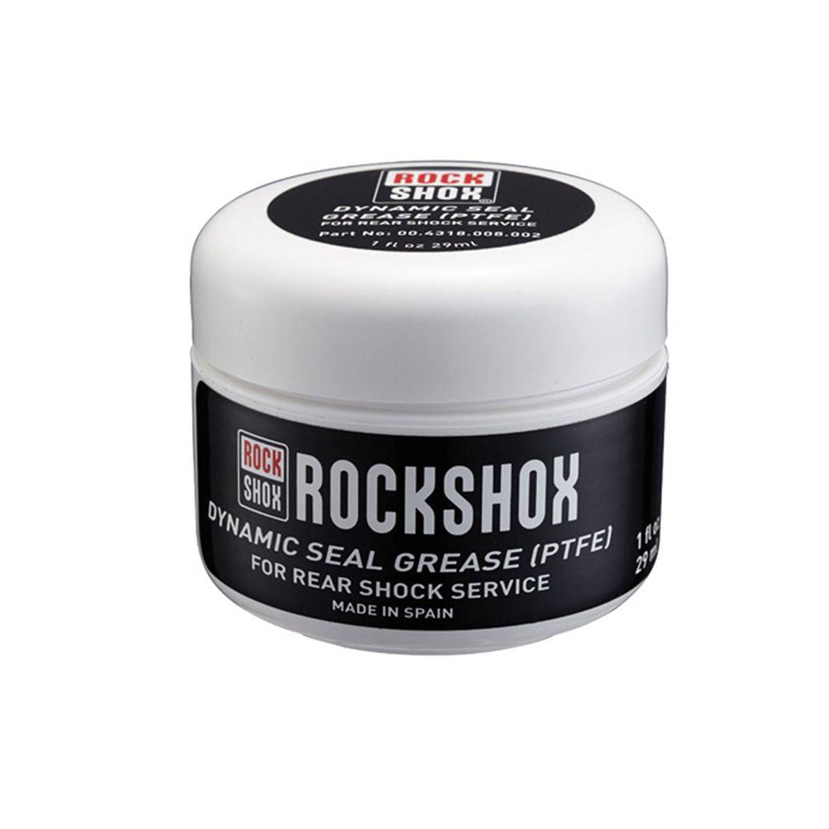 RockShox Dynamic Seal Grease PTFE for rear shock maintenance, shown in a workshop setting with application tools.