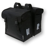 Basil Mara XXL double bike bag in black, water-repellent and reflective, mounted on a bicycle pannier rack for carrying accessories.
