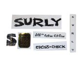Surly MDS dropouts spares and accessories with headbadge for bike frames, showing metal components and branding detail.