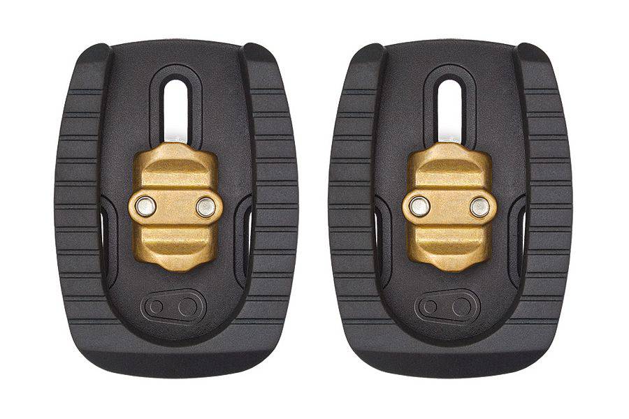 Crankbrothers Quattro black cleat for 3-bolt road shoes, compatible with Eggbeater and Candy pedals, shown mounted on cycling shoe.
