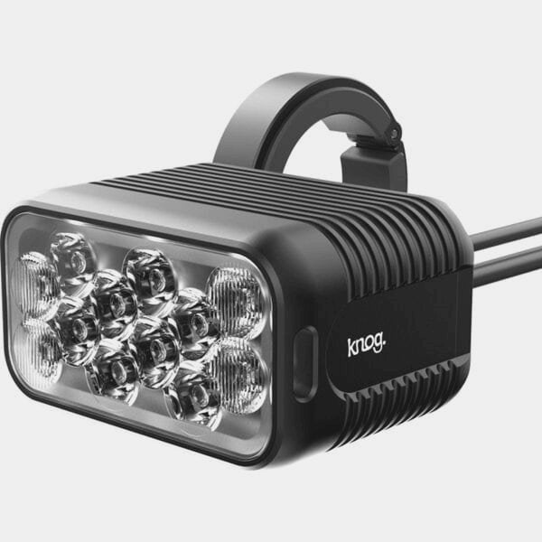 Knog Blinder X 1800 front bike light with 10,000mAh battery pack and remote control, mounted on a bicycle handlebar.