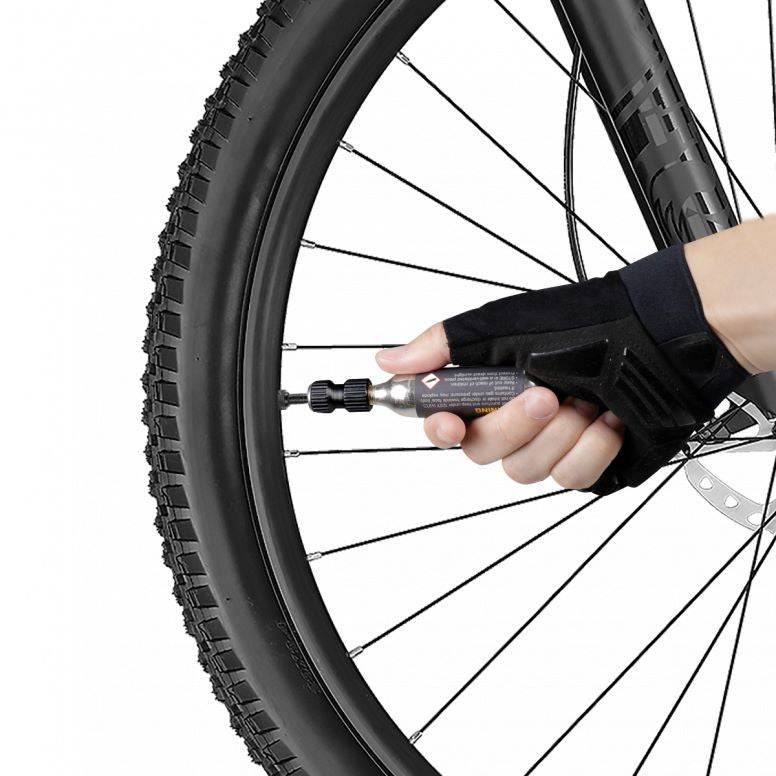 Topeak AirBooster Nano CO2 inflator for Presta and Schrader valves, compact black bicycle pump accessory.