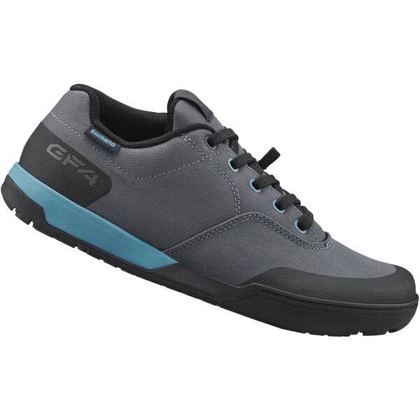 Shimano GF4W women's gravel cycling shoes with flat pedals and ULTREAD grip for secure footing during bike rides.