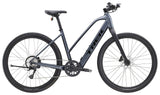 Trek Dual Sport+ 2 Stagger LT 2025 women's low-step electric hybrid bike for commuting and off-road riding, shown outdoors.