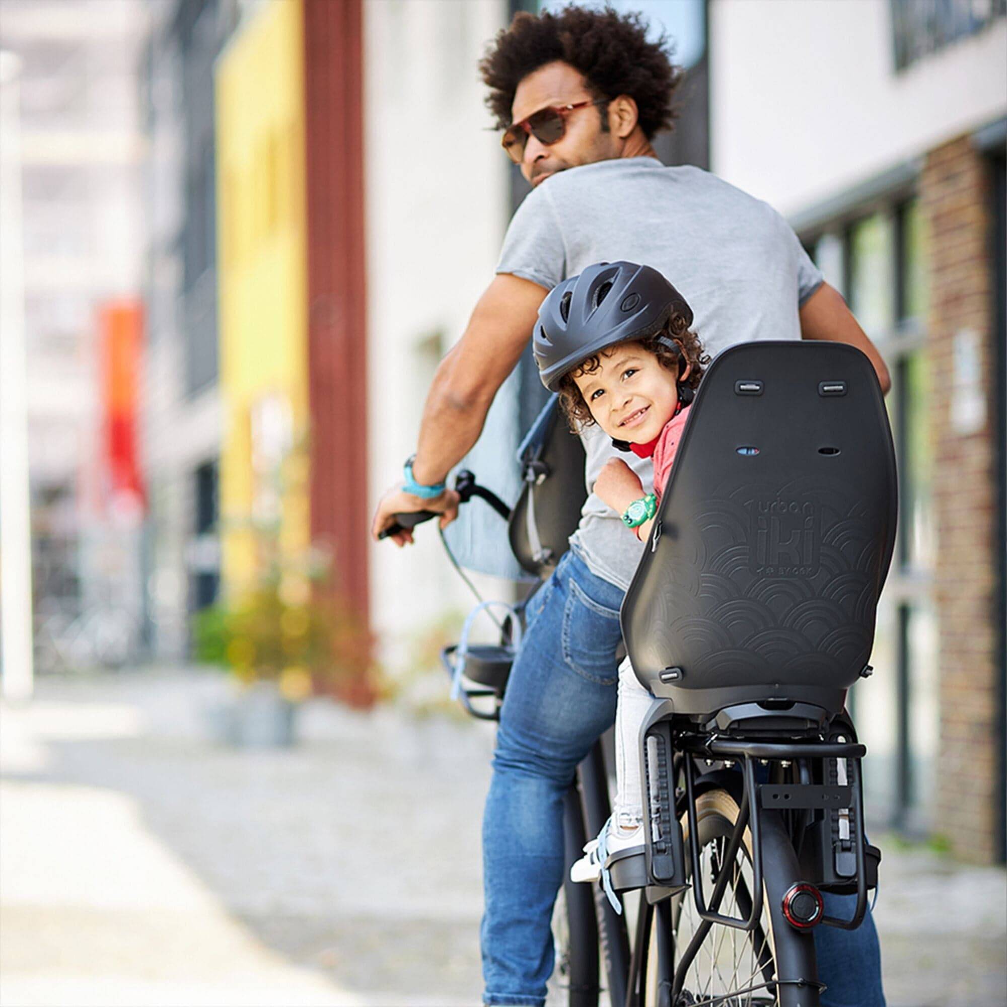 Urban Iki Rear Seat TA-KE carrier mount for kids bike, featuring Click & Go system, shown attached to a bike in the image.