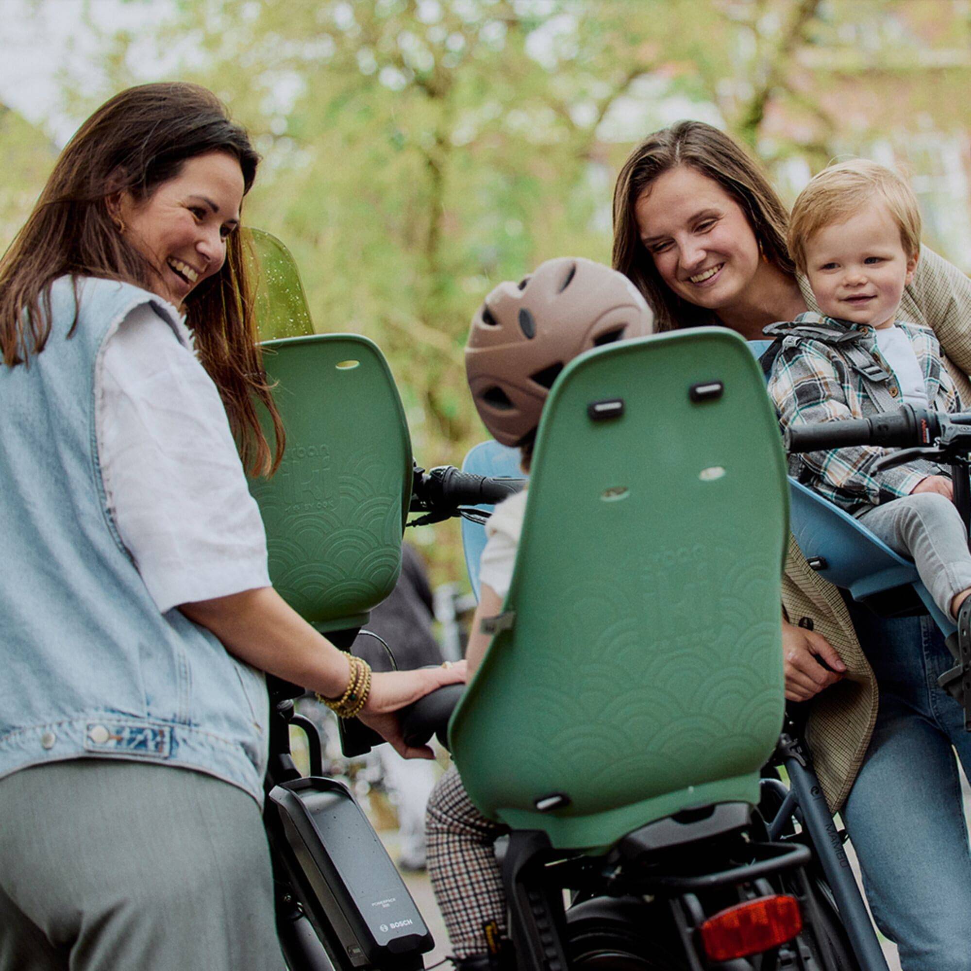 Urban Iki Rear Seat TA-KE carrier mount for kids bike with Click & Go system, shown with attachment components and mounting details.
