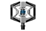 Crankbrothers Double Shot 2 hybrid MTB pedals in black and silver with adjustable cleats, designed for versatile mountain biking.