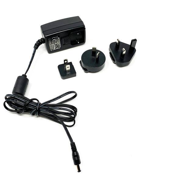 Elite 1.5A power supply for UK, Japan, Australia, and US compatible Elite trainers, shown with connected power cord.