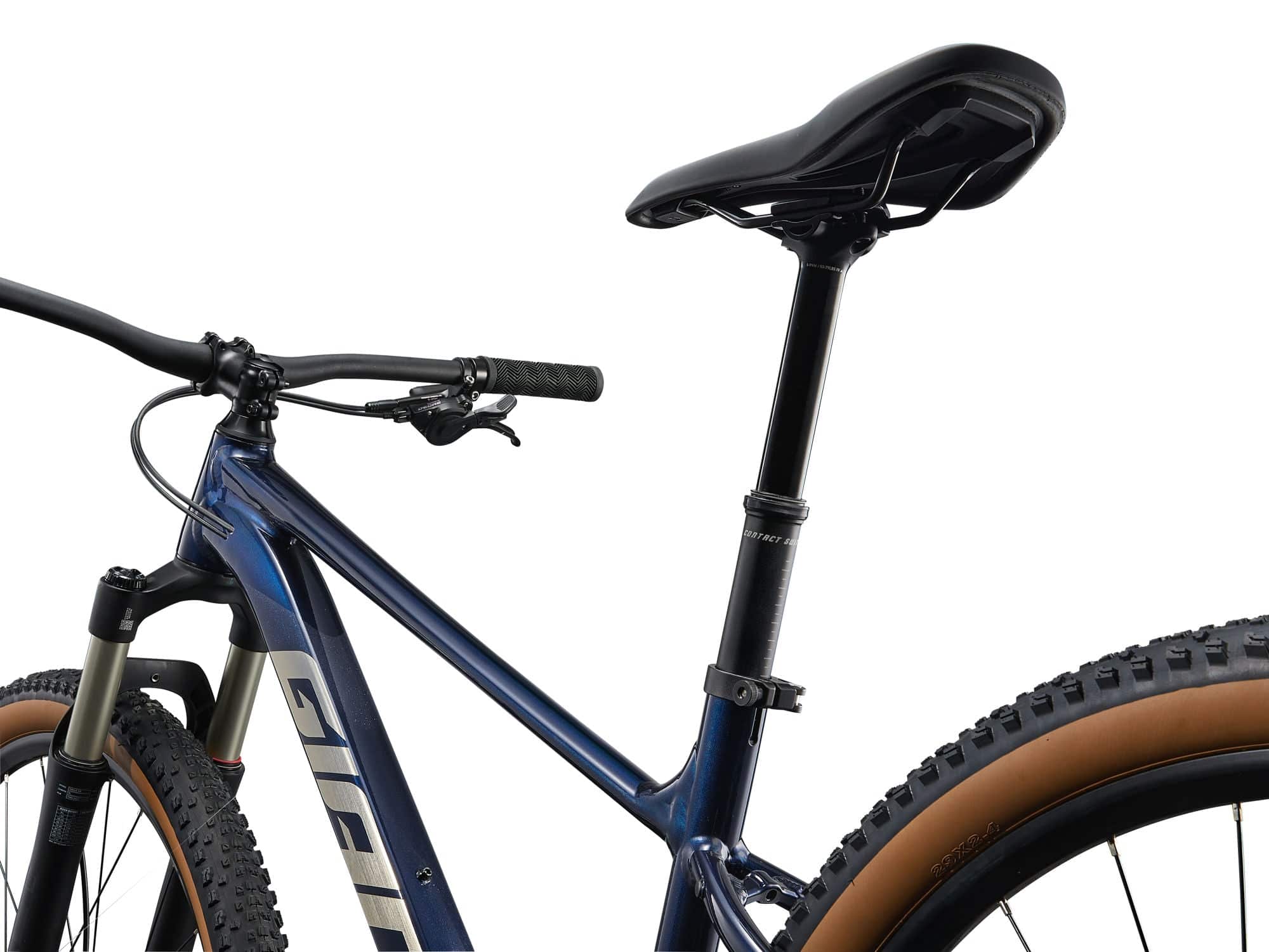 Giant Talon 0 mountain bike with Shimano Deore M6100 drivetrain and suspension forks, shown in a scenic outdoor trail setting.