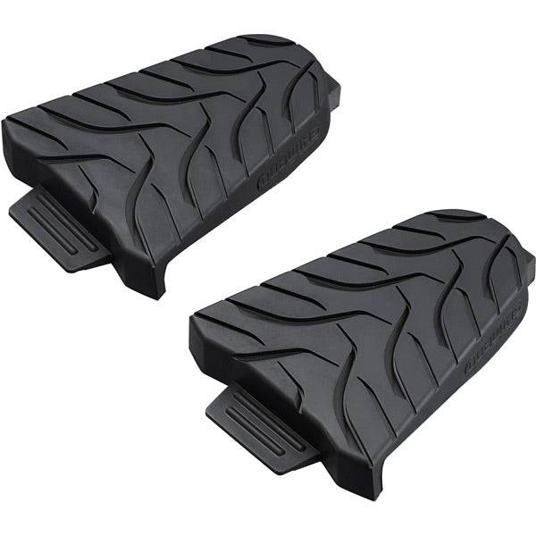 Shimano SPD-SL cleat covers for protection and traction, showing black rubber covers with Shimano branding for cycling shoes.