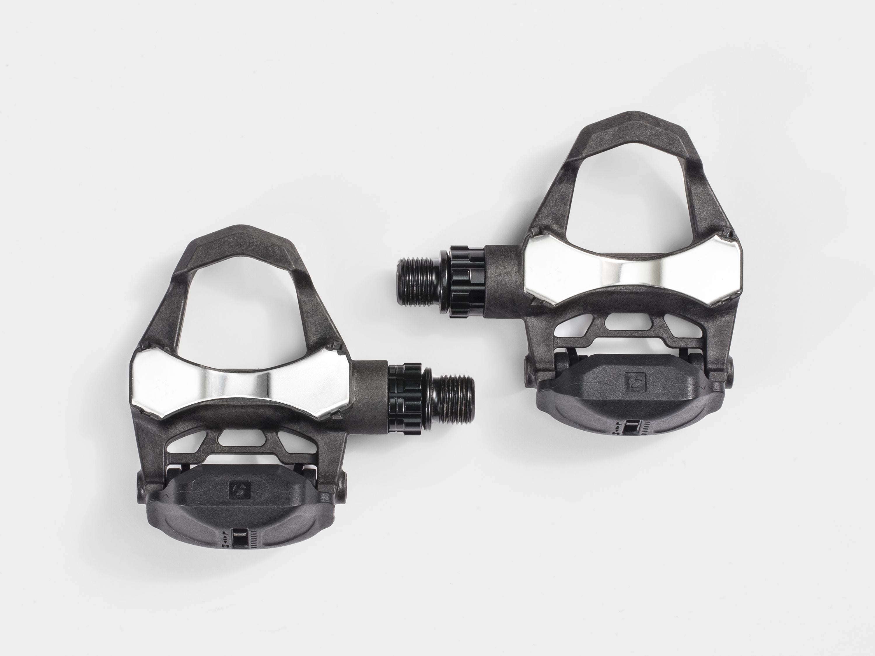 Bontrager Elite Road Pedal Set in black with cleats and adjustable tension on a bike pedal platform.