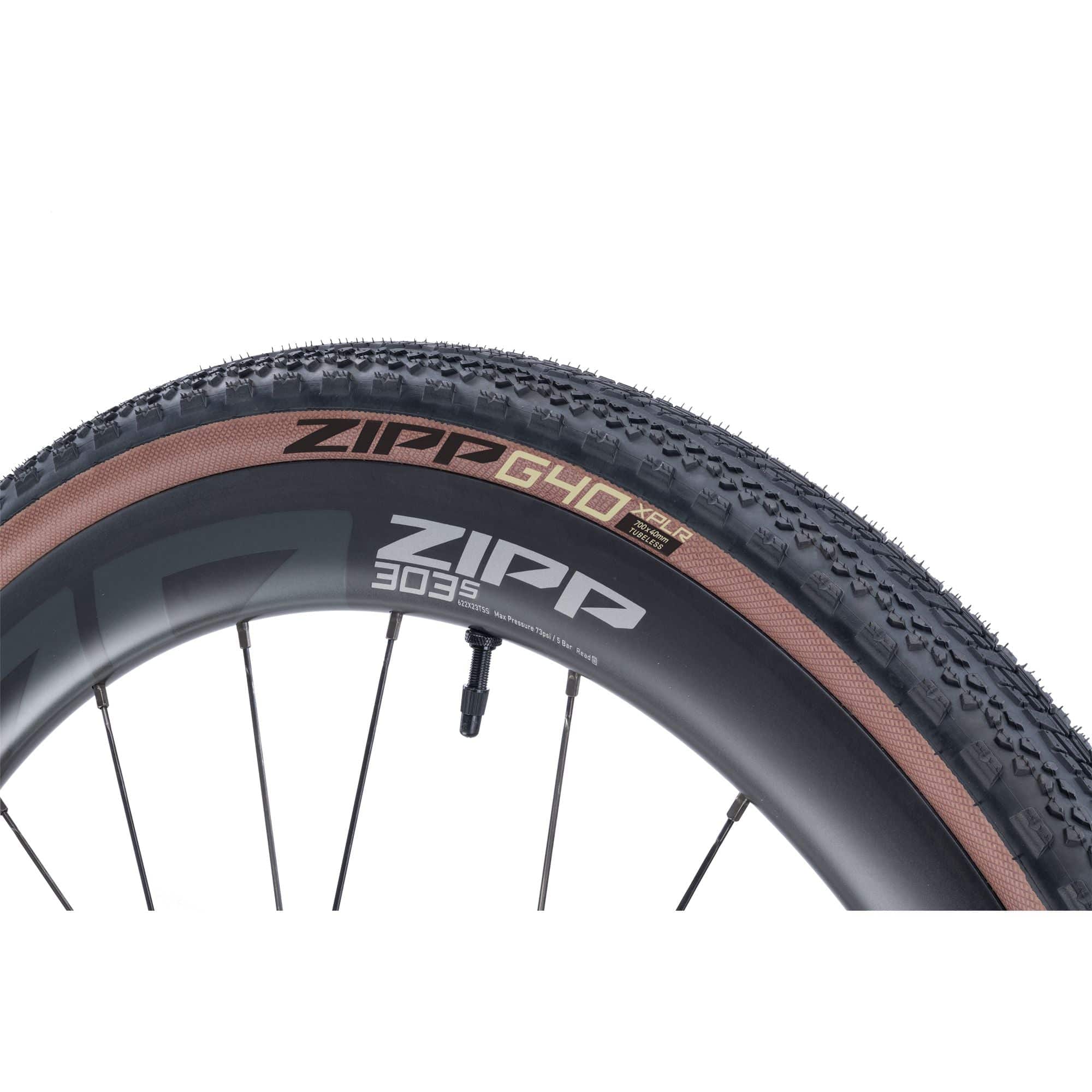 Zipp G40 XPLR 700x40C gravel clincher tire with tubeless ready and puncture-resistant features, mounted on a bike wheel.