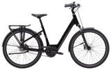 Trek District+ 2 Belt Lowstep Women's E-Hybrid Bike with sleek frame and urban commuting features, parked on city street.