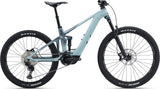 Liv Intrigue X Advanced E+ EL 2 women's electric mountain bike with SyncDrive Pro motor, shown on rugged trail.