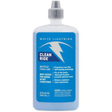 White Lightning Clean Ride dry wax chain lube applying to bicycle chain, self-cleaning bicycle lubricant for bike maintenance.