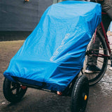 Burley Travoy rain cover with reflective high-visibility strip, providing cargo protection for bike accessories.