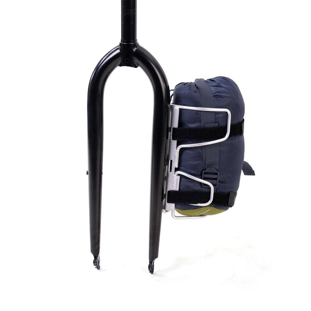 Silver Passport Lug-Kage Rack with adjustable straps securing luggage and gear, shown holding a bag.