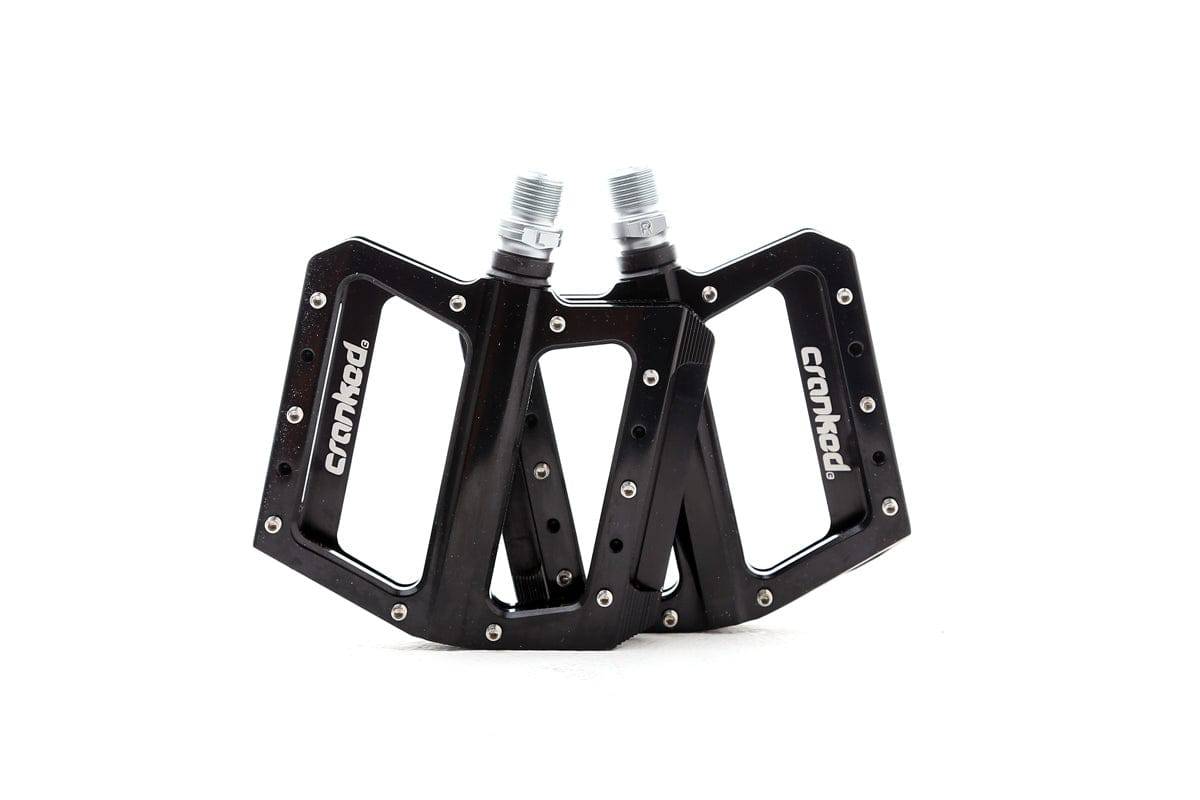 Cranked studded MTB pedal with replaceable pins and sealed bearings, designed for mountain bike riding.