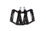 Cranked studded MTB pedal with replaceable pins and sealed bearings, designed for mountain bike riding.