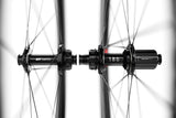 DT Swiss ARC 1100 DICUT carbon clincher rear wheel with 65x22mm rim and disc brake, showing the sleek aerodynamic design.