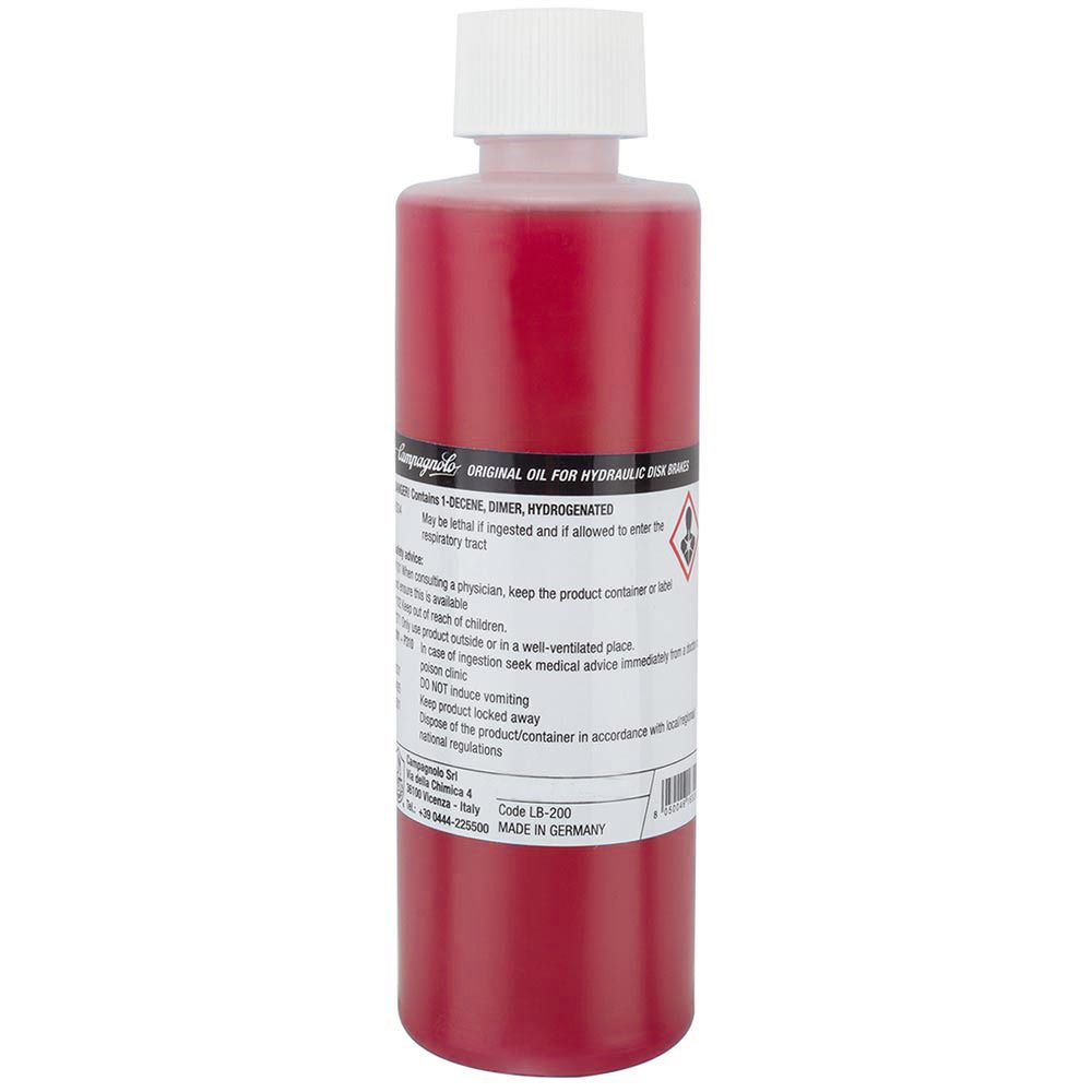 Campagnolo Mineral Oil Brake Fluid for hydraulic disc brake systems, shown in a workshop setting, ready for maintenance use.