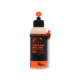 Orange Seal tubeless sealant with injector for fast puncture repair, designed for bicycle wheels and tubeless tire maintenance.