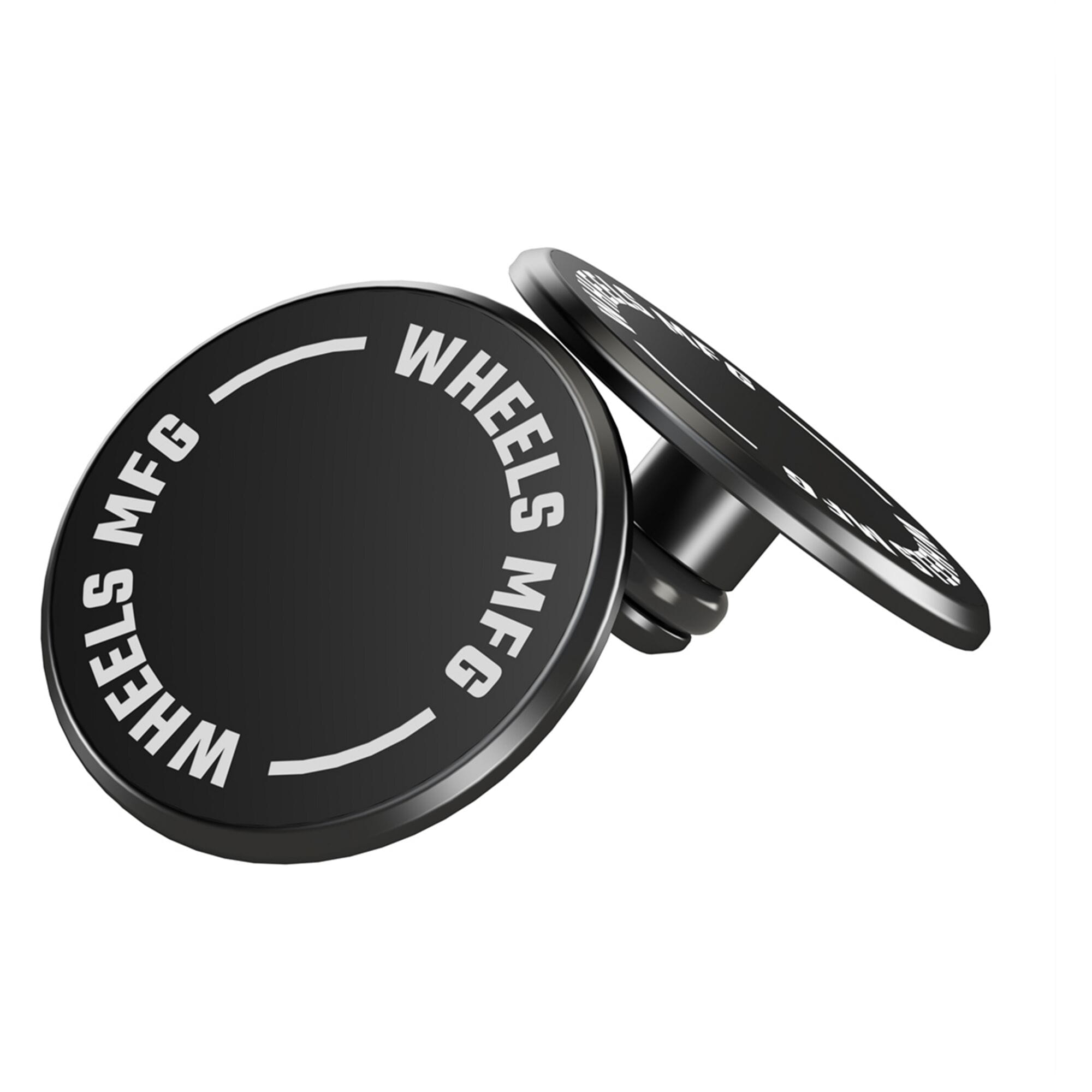 Pair of Wheels Manufacturing black thru-axle caps for bike protection and style, shown on a bike component.