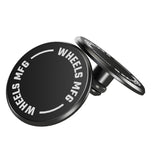 Pair of Wheels Manufacturing black thru-axle caps for bike protection and style, shown on a bike component.