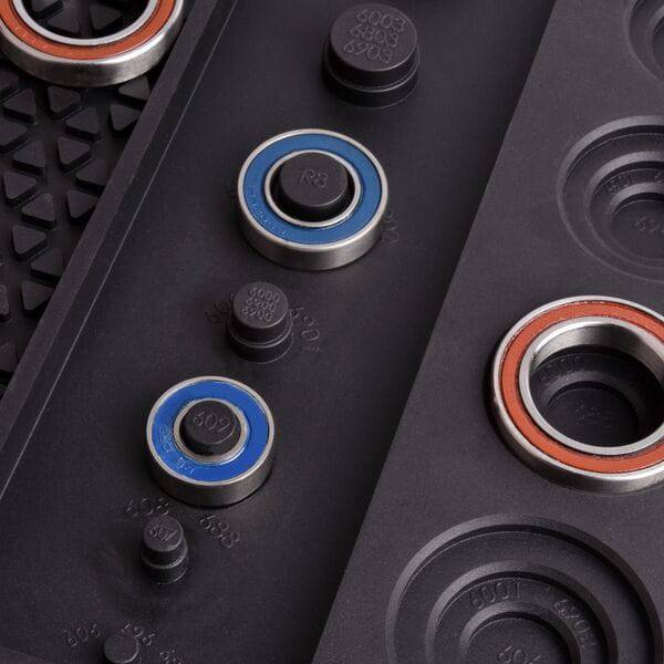 Wheels Manufacturing Ultimate Benchtop Workshop Mat with tool compartments and bearing gauges for organized workspace.