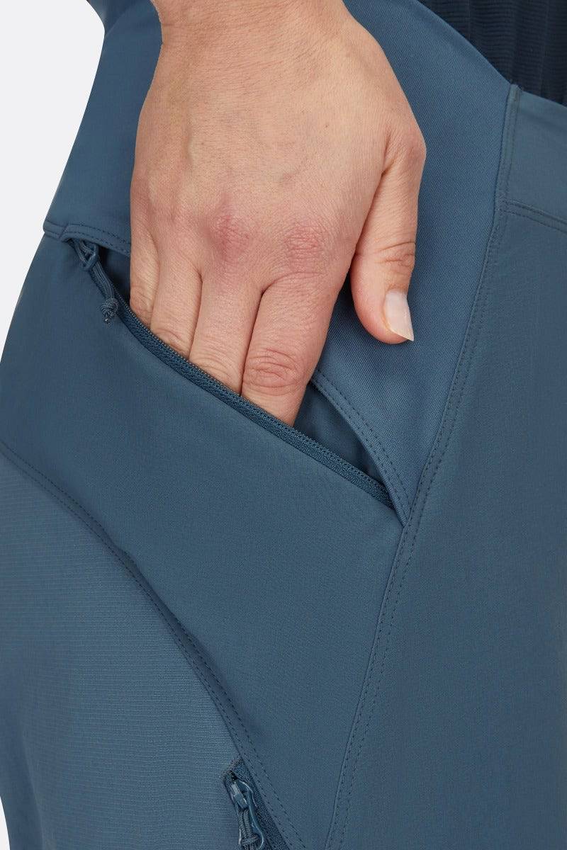 Rab Cinder Crank women's cycling softshell pants in Orion Blue, showing close-up detail of durable, breathable fabric and fit.