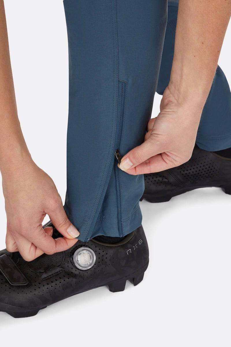 Rab Cinder Crank women's cycling softshell pants in Orion Blue, showing the durable, breathable fabric and fit detail.