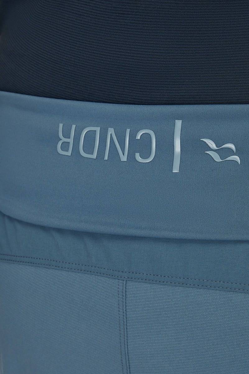 Rab Cinder Crank Women's Cycling Softshell Pants in Orion Blue, showing the durable, breathable fabric and fit for active cycling.