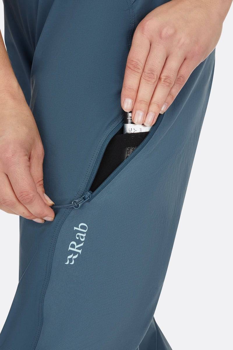 Rab Cinder Crank women's cycling softshell pants in Orion Blue, showing the durable, breathable fabric and close fit detail.