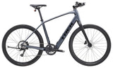 Trek Dual Sport+ 2 LT 2025 electric hybrid bike with sleek frame, mountain and urban tires, and handlebar controls for versatile riding.