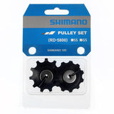 Shimano 105 R7000 rear derailleur pulley set with durable components for smooth shifting on road bikes.