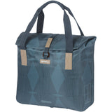 Basil Elegance bicycle shopper bag in estate blue with hook-on system, showing the bag attached to a bicycle rack.