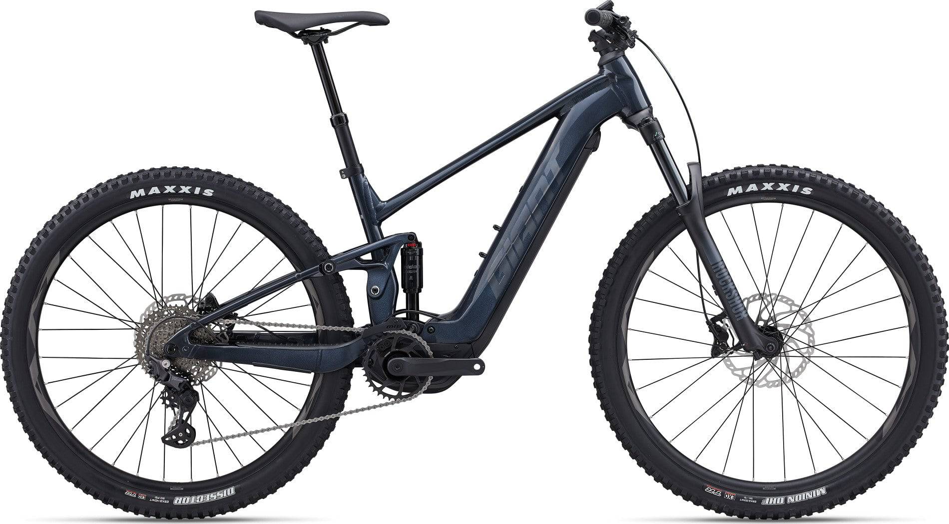 Giant Stance E+ 1 e-Mountain Bike with 29-inch wheels and SyncDrive Sport motor, shown from side view on rugged trail