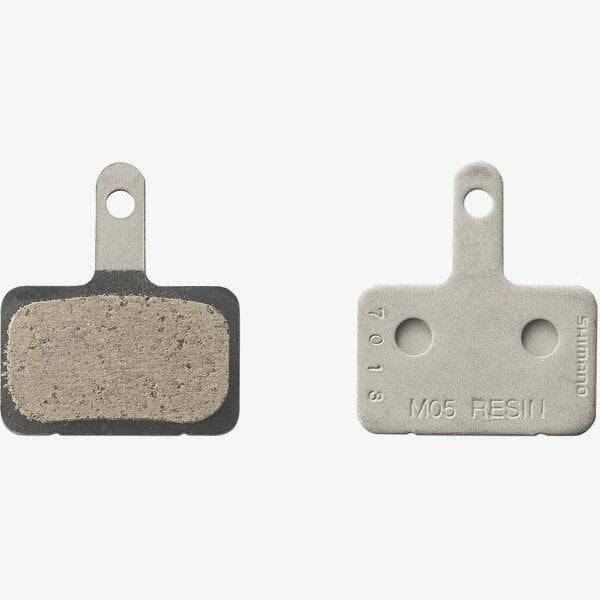 Shimano M05-RX resin disc brake pads with steel back plate for 2 piston bike brake systems, showing the brake pad surface and backing plate.