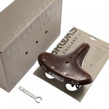 Brooks B72 unisex bicycle saddle with loop suspension, designed for comfortable upright riding, shown from a side view.